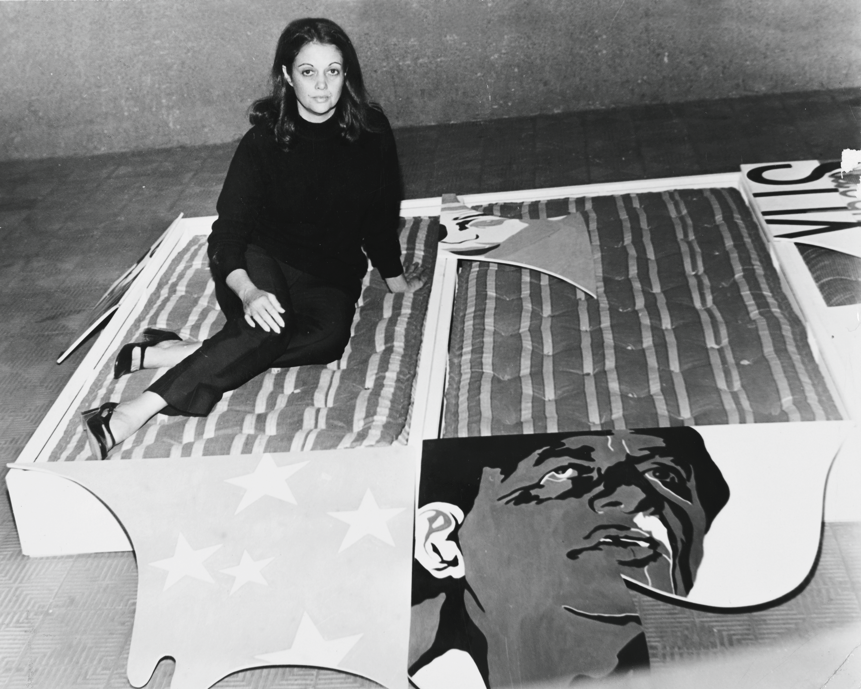 Portrait of Teresinha Soares with the work "Ela me deu a bola (Camas)," 1970. © Courtesy Gomide&Co and Atelier Teresinha Soares